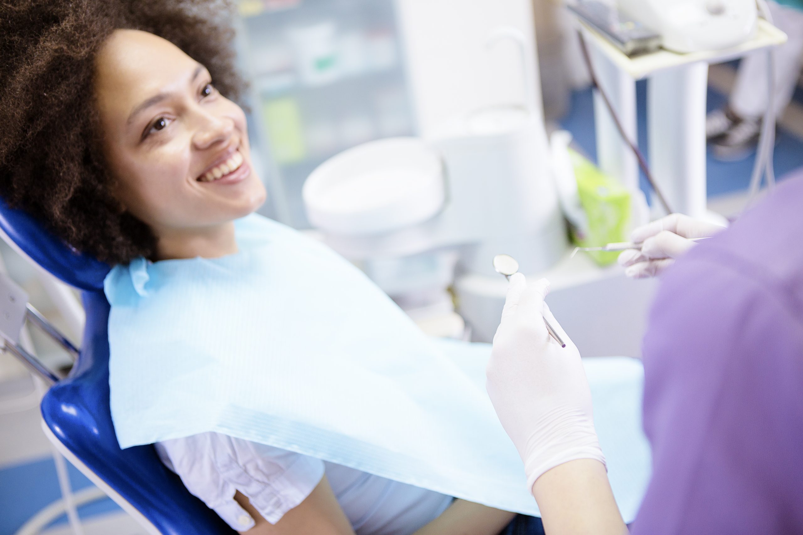 Patient in dentist chair smiling