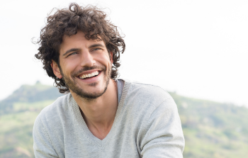 Brown haired with invisalign man smiling