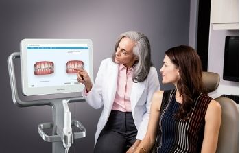 Patient being shown how her teeth will change with the Invisalign process