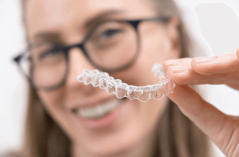 woman placing Invisalign braces in her mouth in Wolverhampton