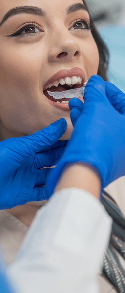 Wolverhampton dentist inserting Invisalign braces into patient's mouth