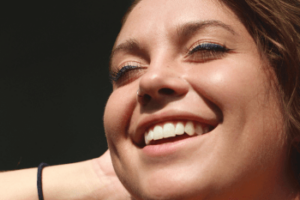 Woman with invisible braces in Wolverhampton dental practice smiling