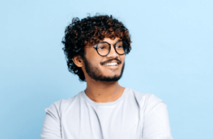 man with good dental care smiling whilst looking to his right.