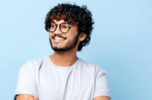man with good dental care smiling whilst looking to his left.
